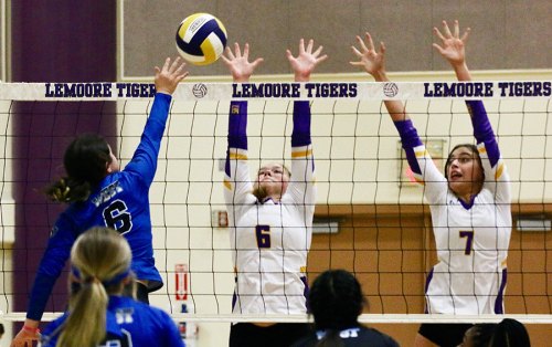 Lemoore's Elizabeth Schalde and Ava Cunningham go high to block a Hanford West shot.